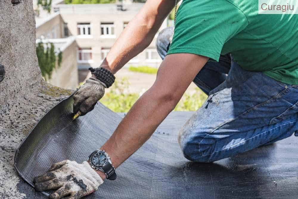 Trabajador poniendo tela asfáltica