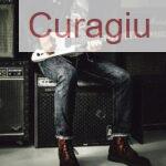 Man Sitting on Guitar Amplifier Playing Electric Guitar