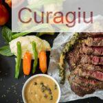 Grilled steak served with fresh vegetables and pepper sauce, presenting a colorful and appetizing meal.