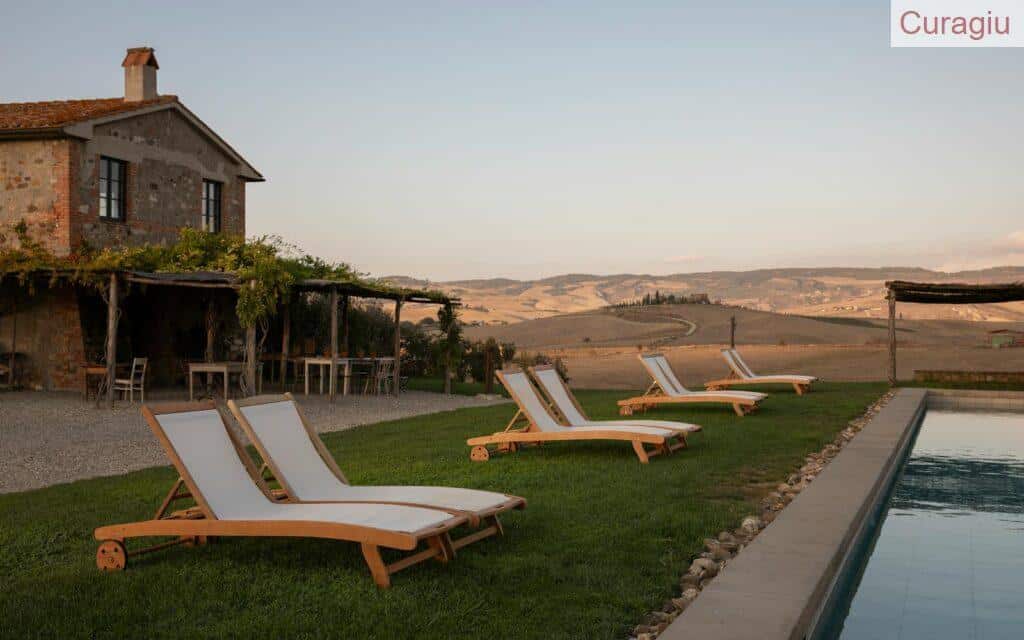 Relaxation by the pool at a scenic countryside retreat with loungers.