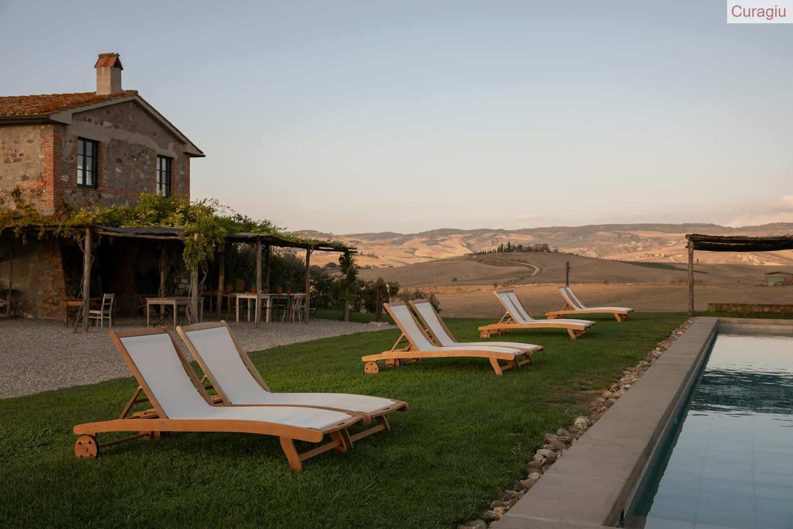Relaxation by the pool at a scenic countryside retreat with loungers.